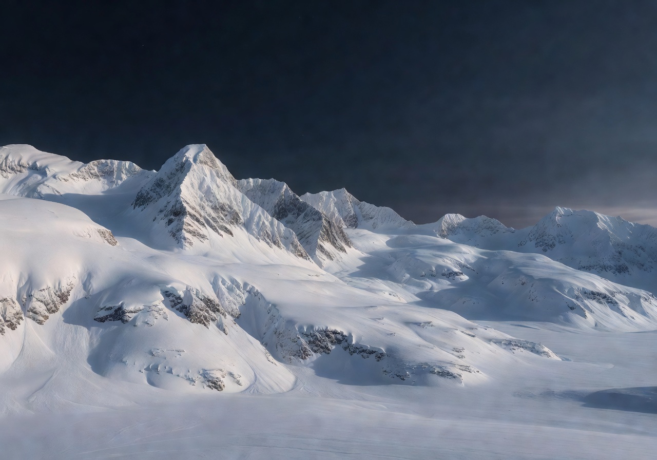 Serene view of pure snow covered arctic mountains and dark winter sky